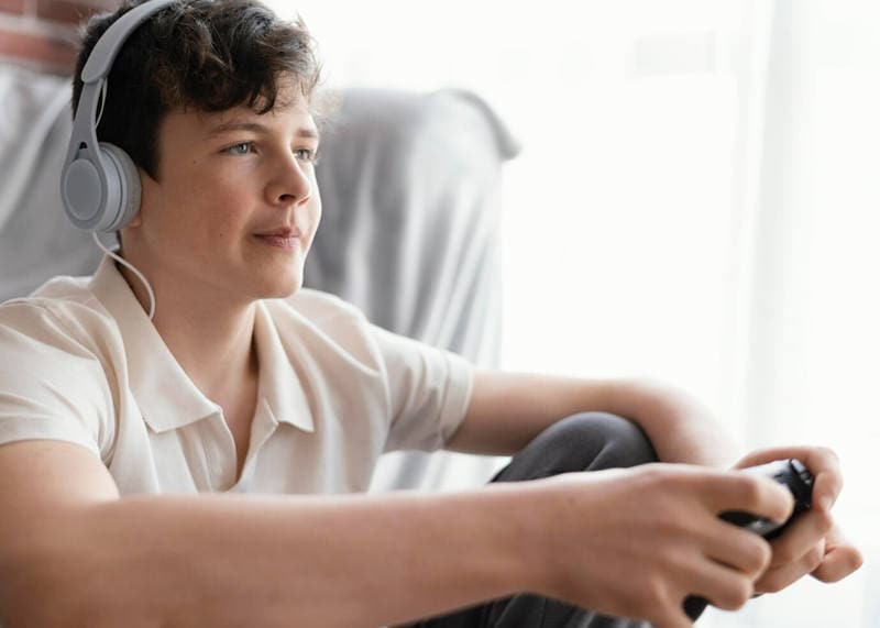 smiling teen playing online