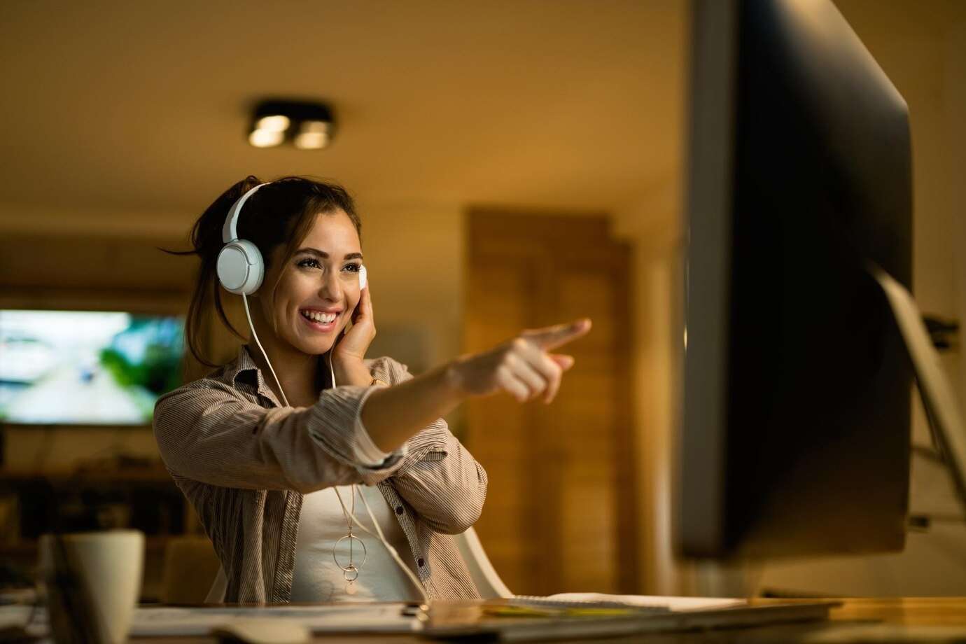 woman pointing at screen while recording