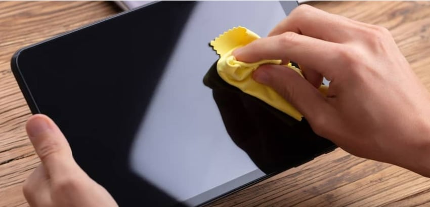 cleaning tablet screen with microfiber cloth