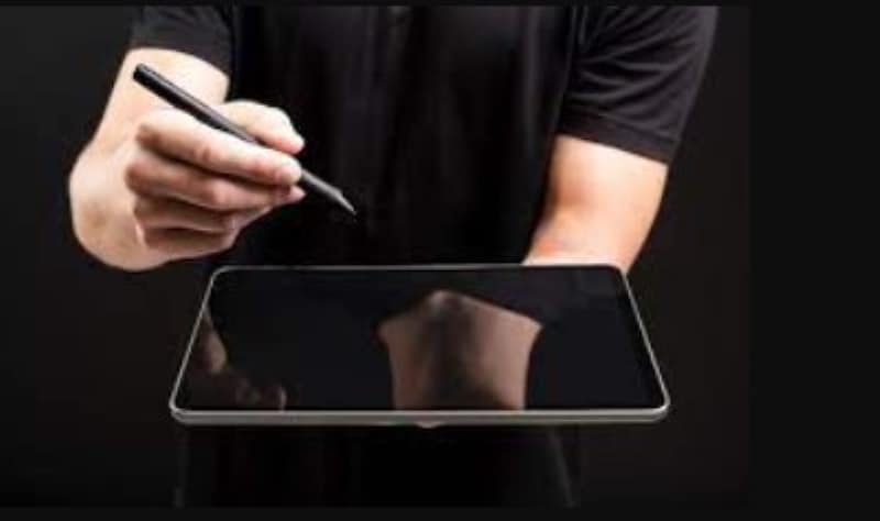 person holding a gadget with pen