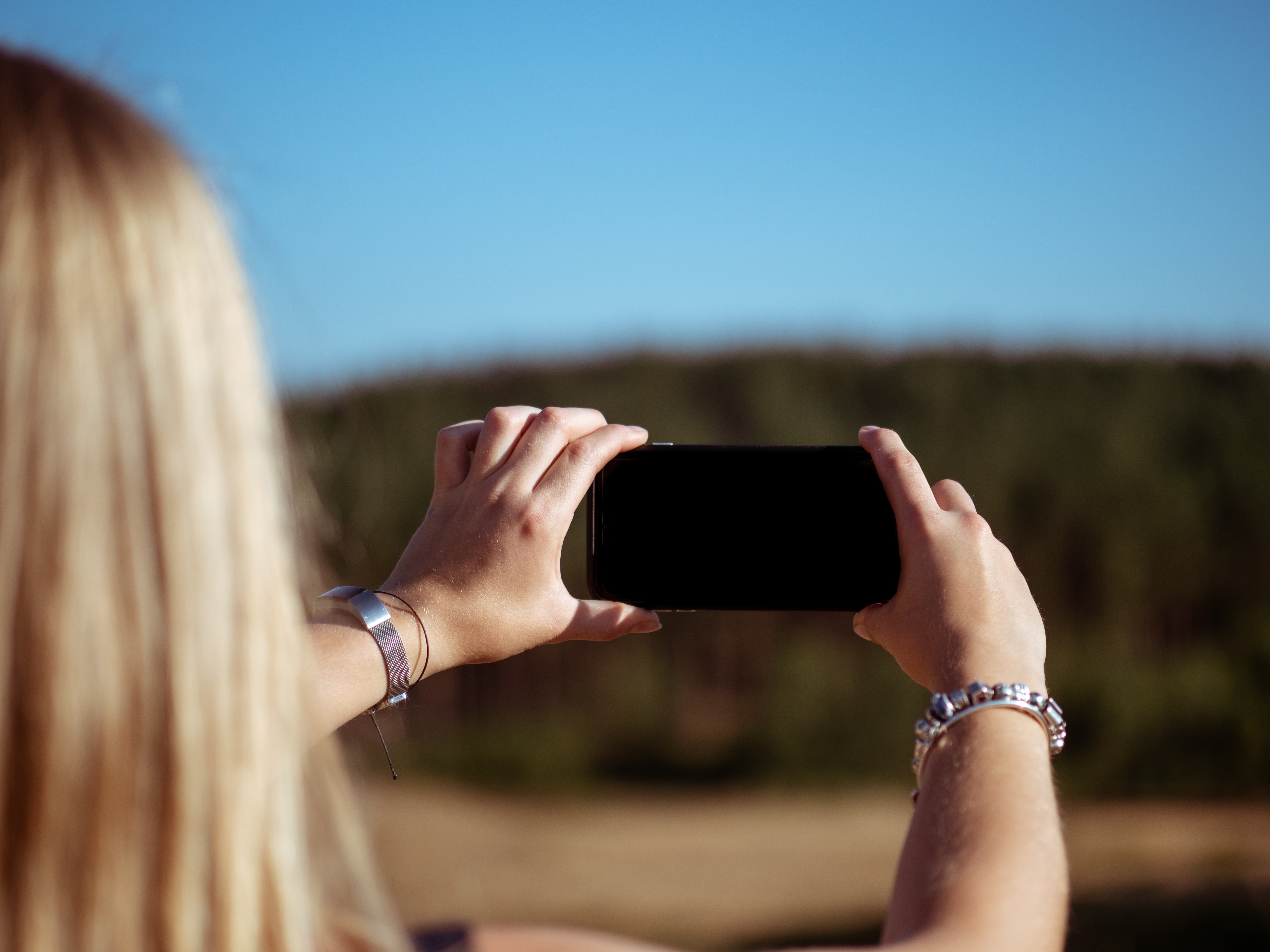 person holding a phone with black screen