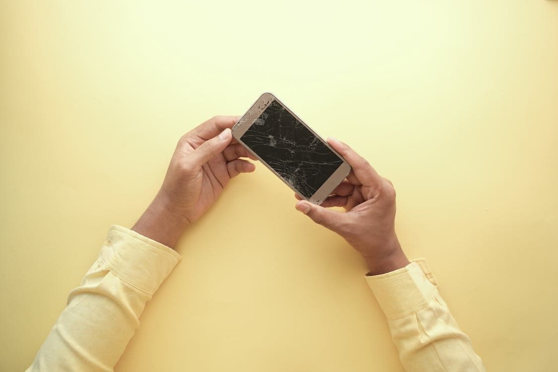 man holding a bricked phone