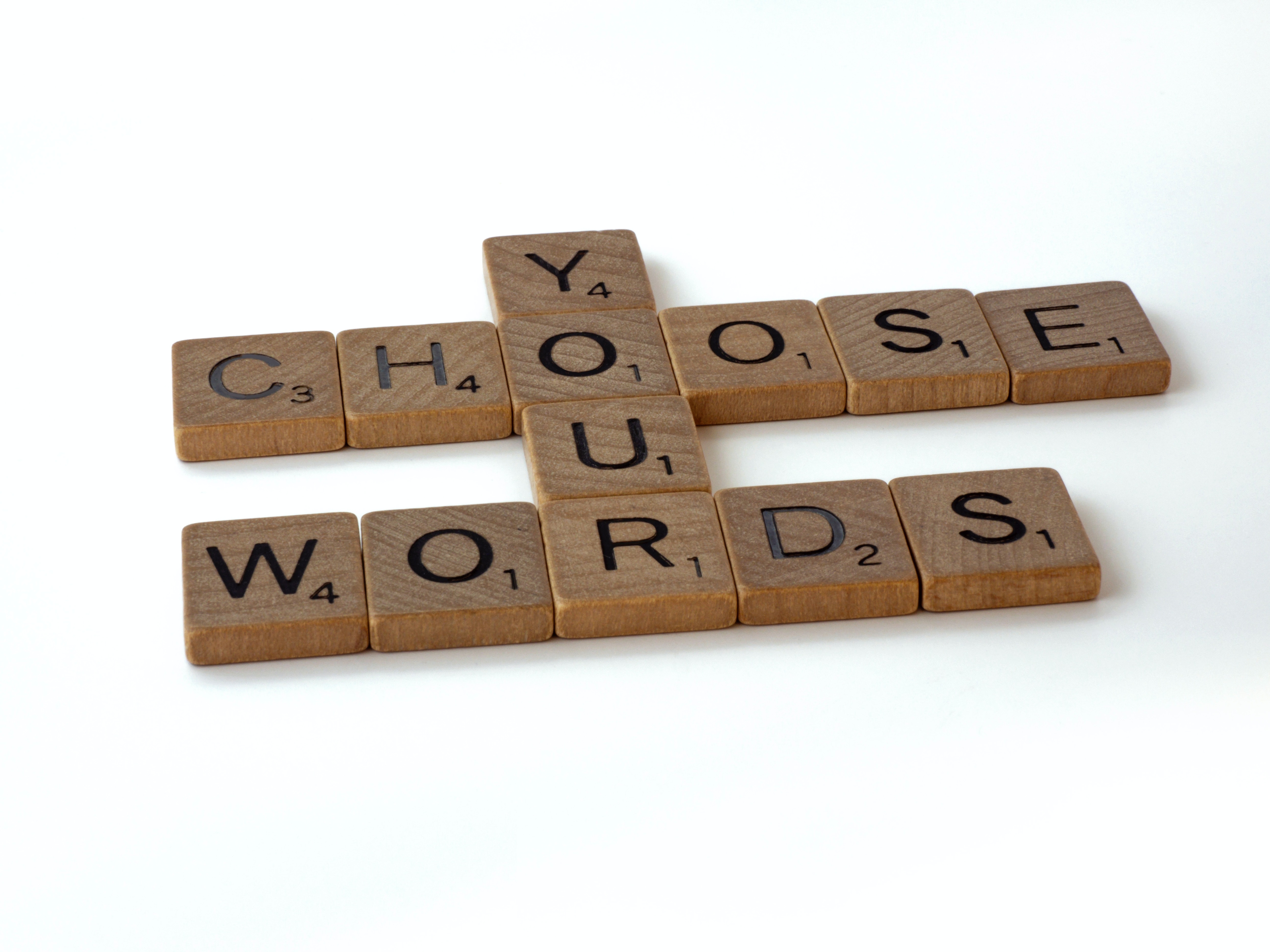 wooden tiles spelling out “choose your words”