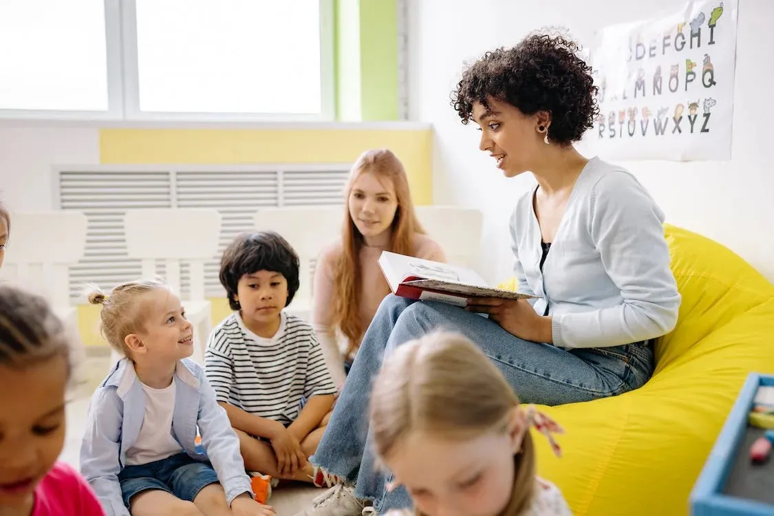 Profesora leyéndoles un libro a los niños