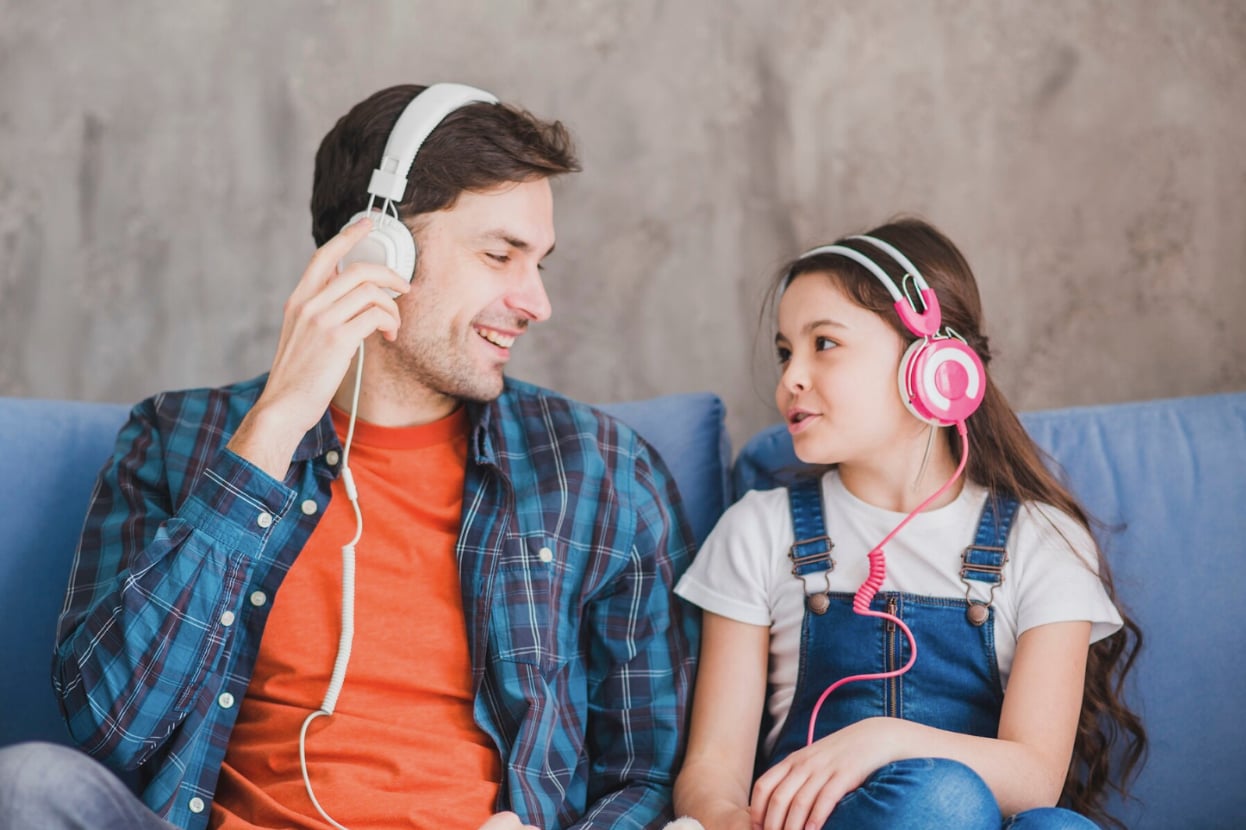 father and daughter listening to music
