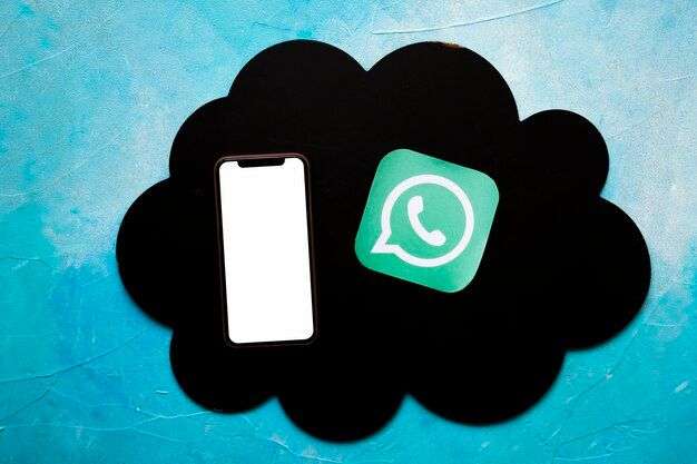 photo smartphone and whatsapp icon on black cloud over the painted blue wall