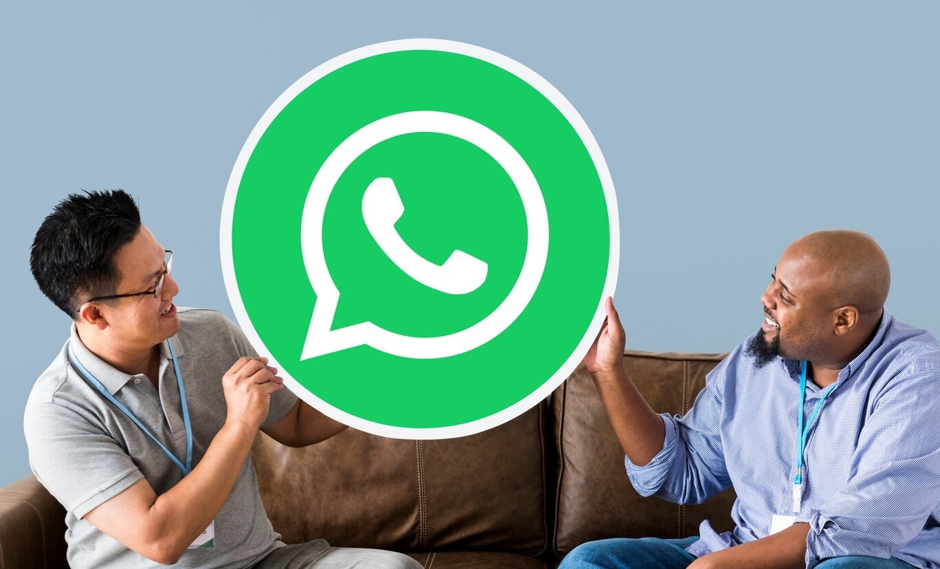 men showing whatsapp icon