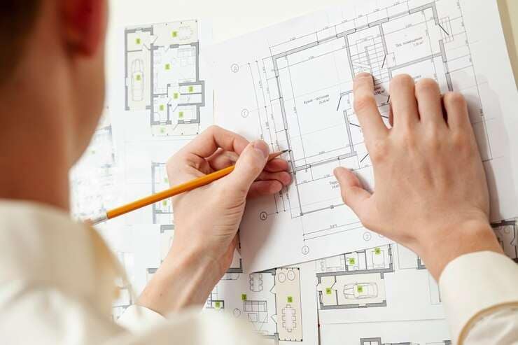 architect drawing walls on floor plan