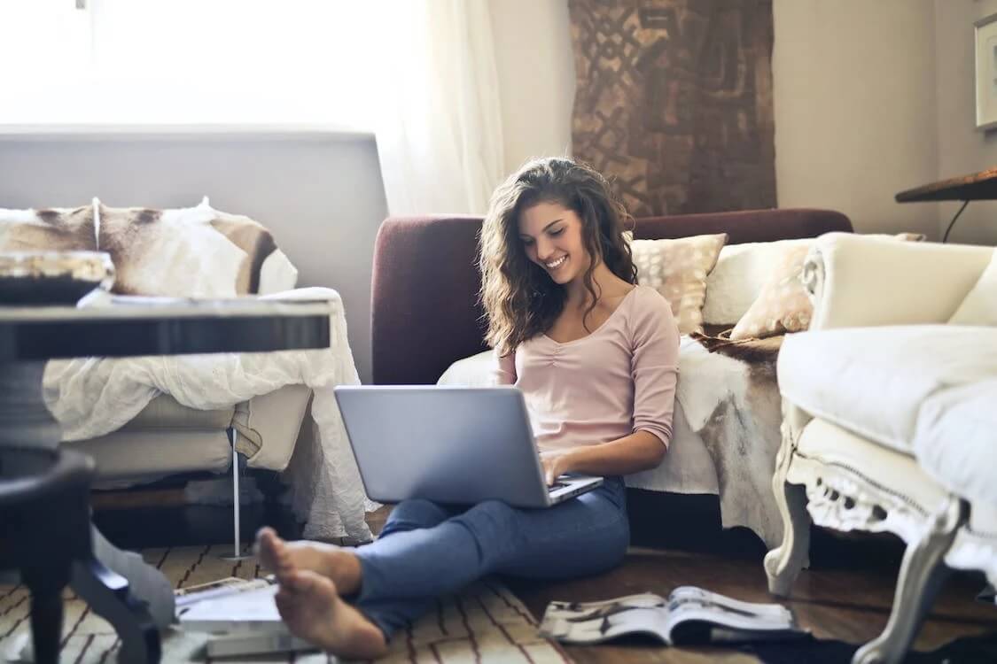 Smiling person using laptop