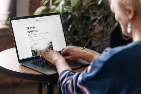 woman typing an article on a laptop