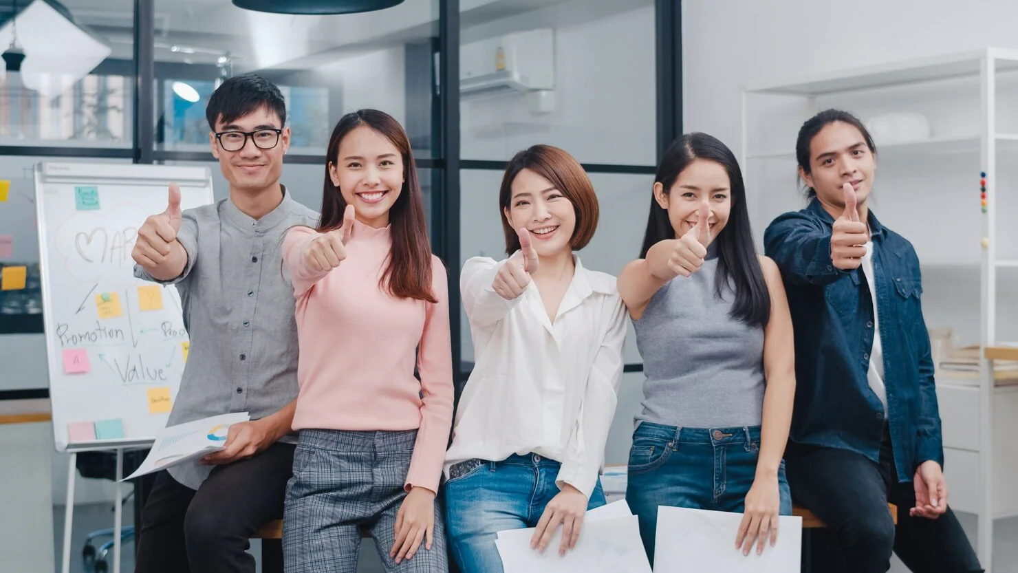 group of creatives posing in workplace