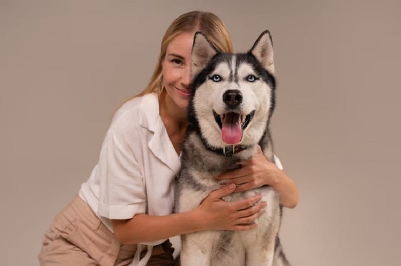 woman posing with pet dog