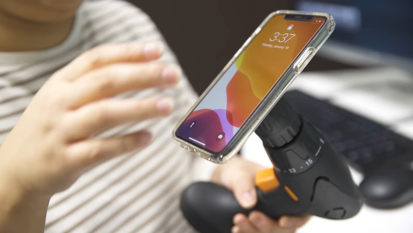 smartphone attached to the power drill