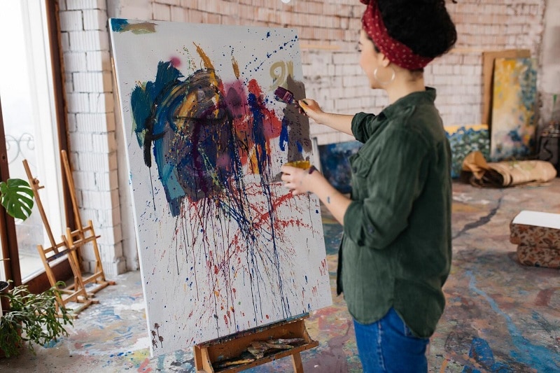 woman painting on canvas