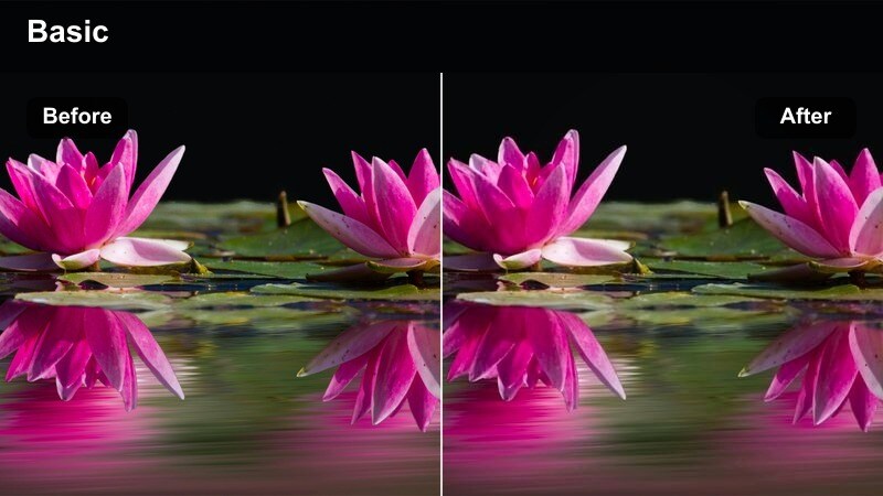 Creator filming a mirror outfit video in a warm-lit apartment bedroom.