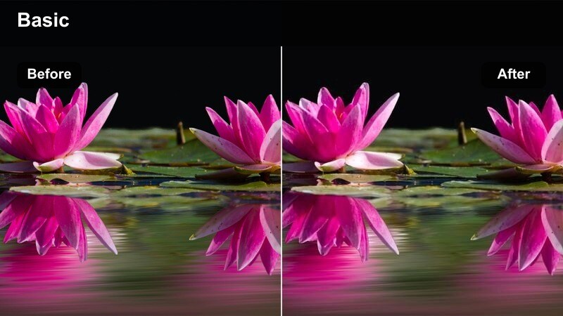Model sitting on a couch in a dim apartment with warm, muted tones and deep corners.