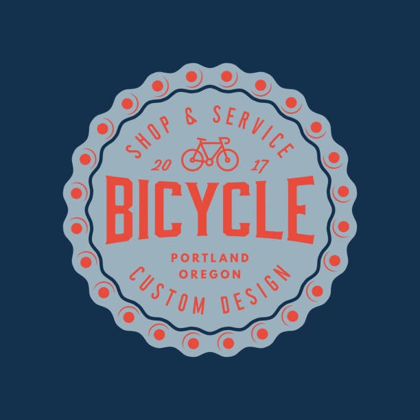 Retro bicycle badge logo in red and navy with old-school typography