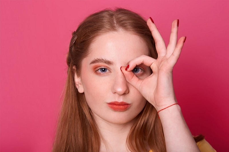 young woman makes ok sign