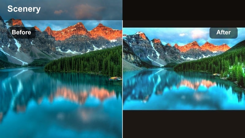 Soft sunrise light touching a mountain peak with muted valleys below