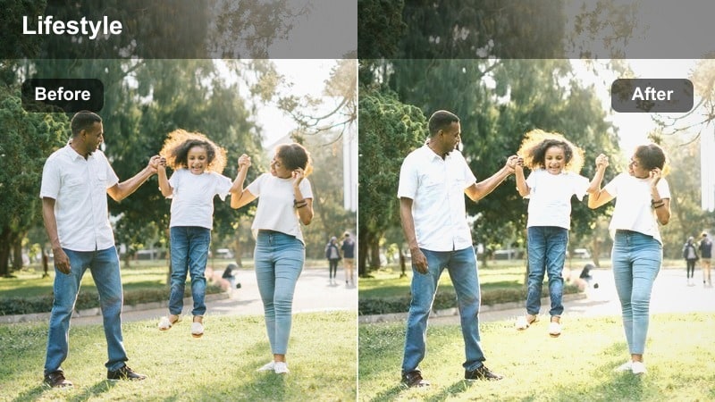 Silhouetted person walking between tall city buildings with a hazy golden glow.