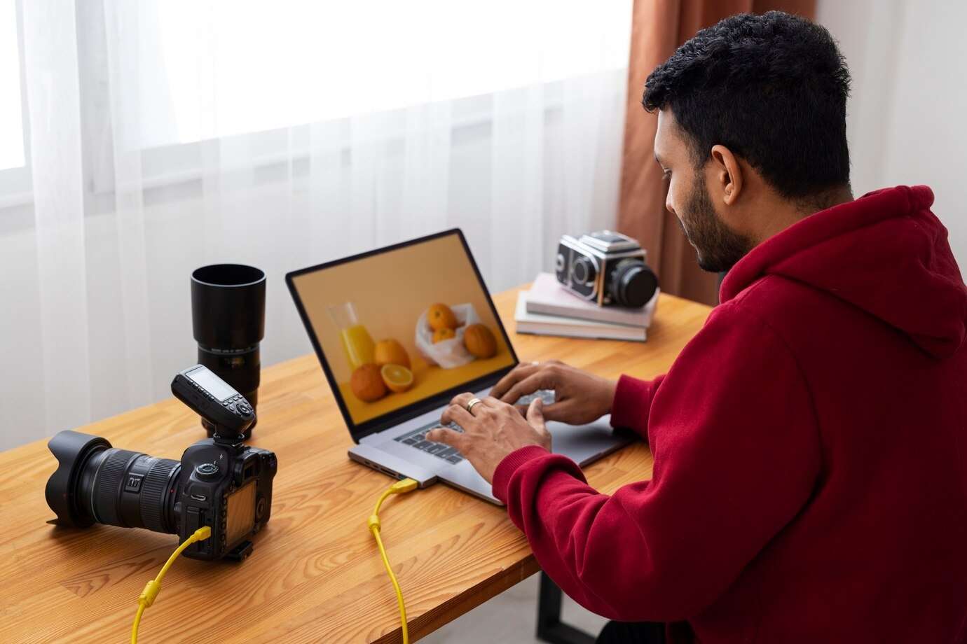 man editing video files on laptop