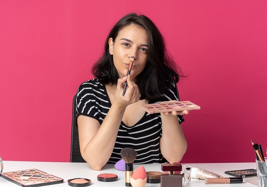 young woman using makeup