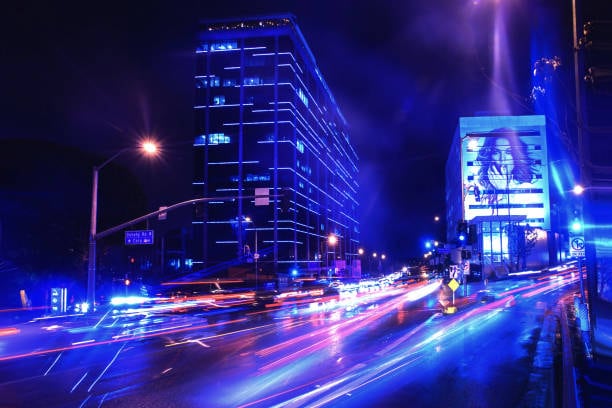 Neon filter adding glowing blue outlines to a nighttime street scene in Filmora
