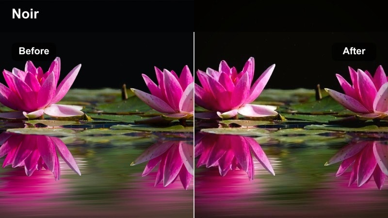 Person walking on a wet city sidewalk at night under glowing streetlamps