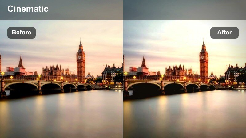 City skyline and highway seen from an overpass at sunrise in warm tones.
