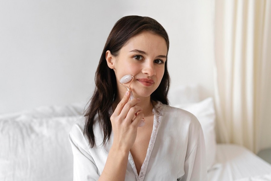 pretty woman performing skin care