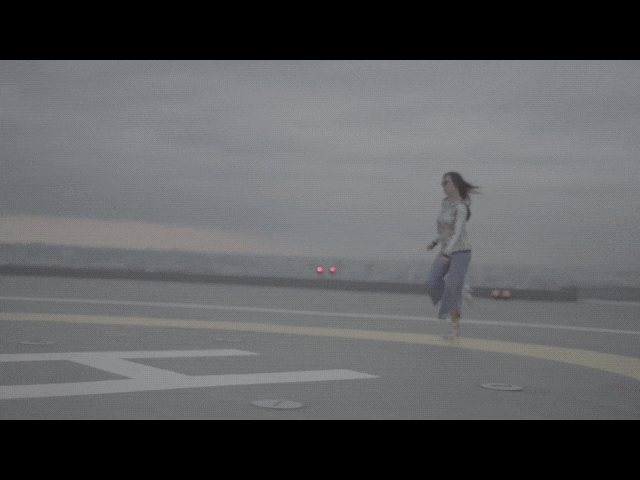 girl bouncing around rooftop