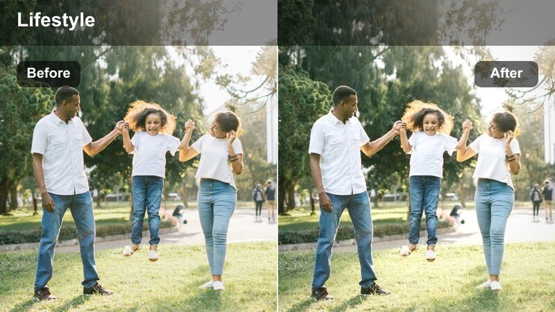 Model walking across a studio set with strong spotlight-style contrast.