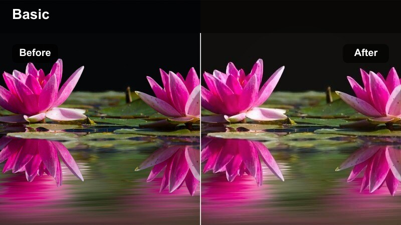 Vlogger holding a coffee cup toward the camera in a golden-lit café interior.
