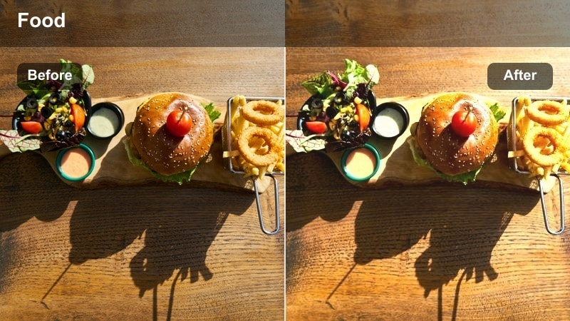 Person walking along a city sidewalk lined with cafes during sunset with a hazy glow.