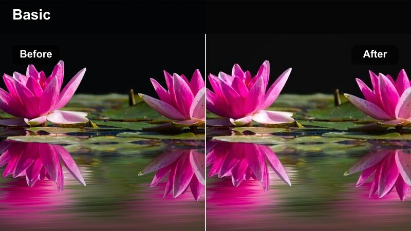 Cook stirring a pot on the stove lit mainly by warm range hood lights.