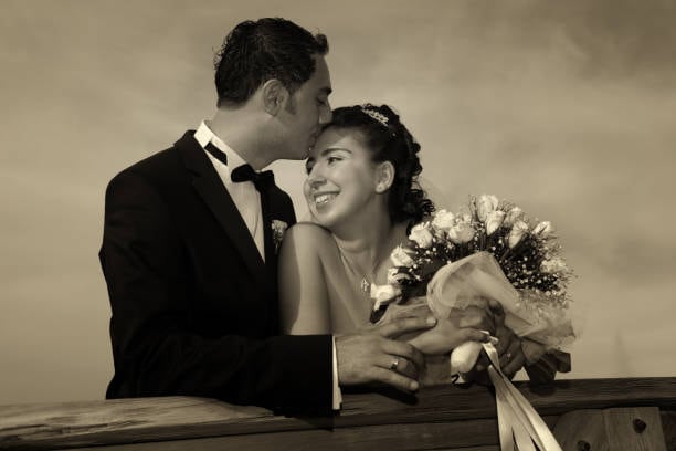 Black-and-white wedding photo with a sepia tone for vintage charm.