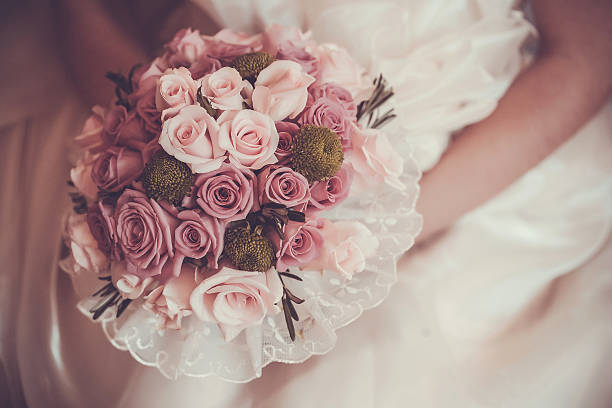 Bride holding a bouquet with a romantic pink tint from the Rose Tone filter.