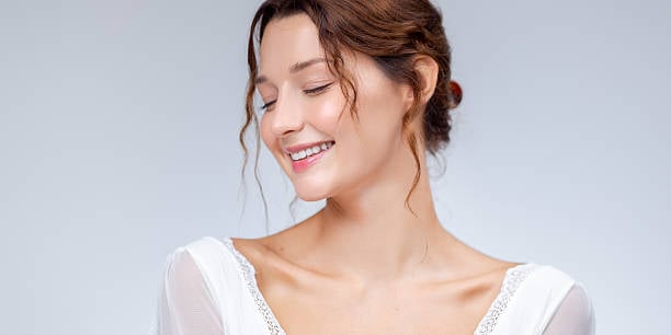 Close-up of a smiling bride with glowing skin enhanced by the Bridal Glow filter.