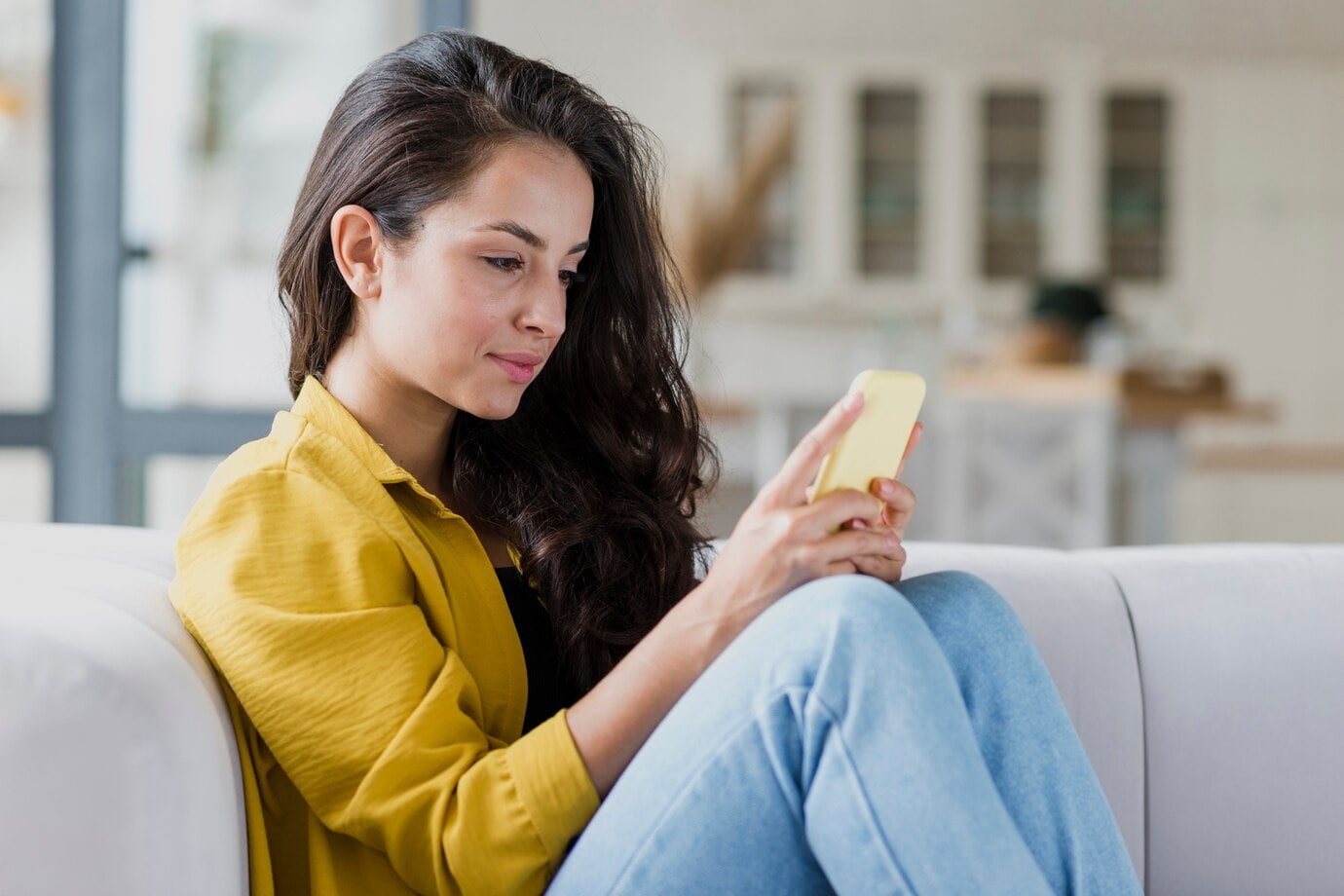 Junge Frau benutzt iPhone zum Lesen