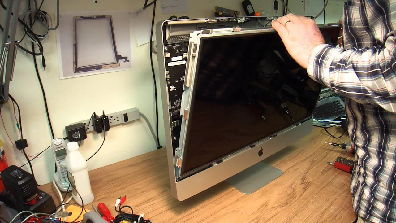 a professional fixing an imac