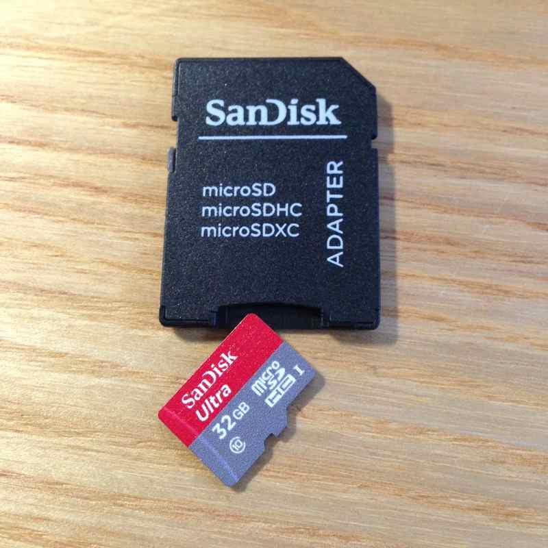 microsd tf card beside a compatible full size sd adapter