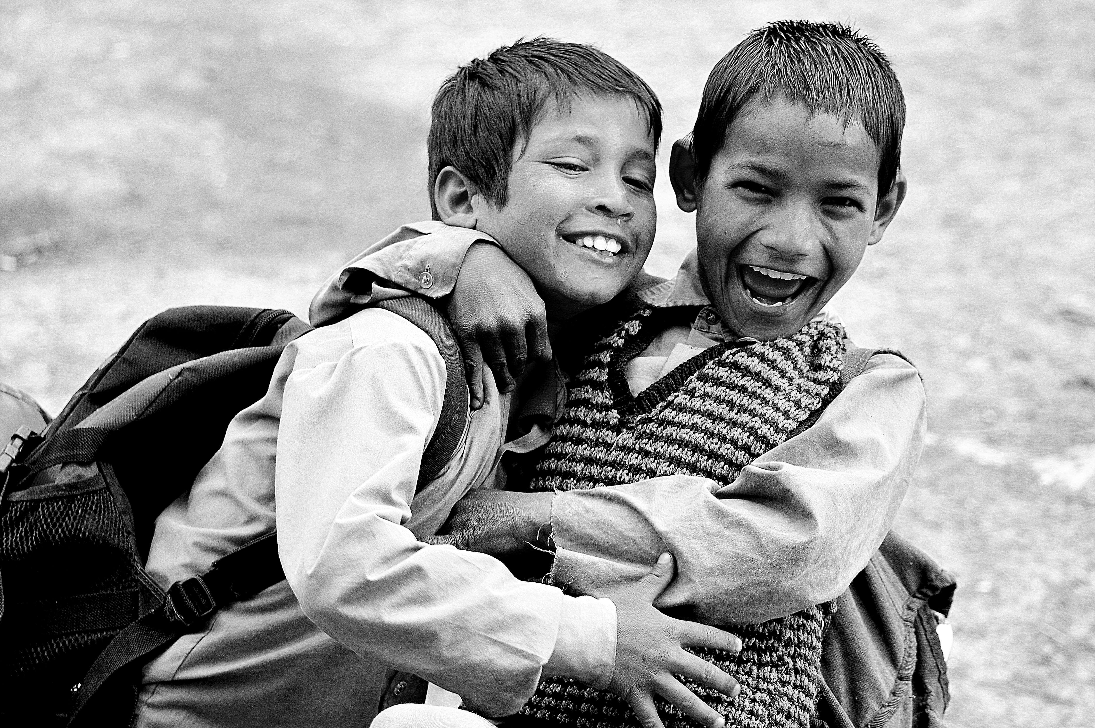black and white photo of children hugging 
