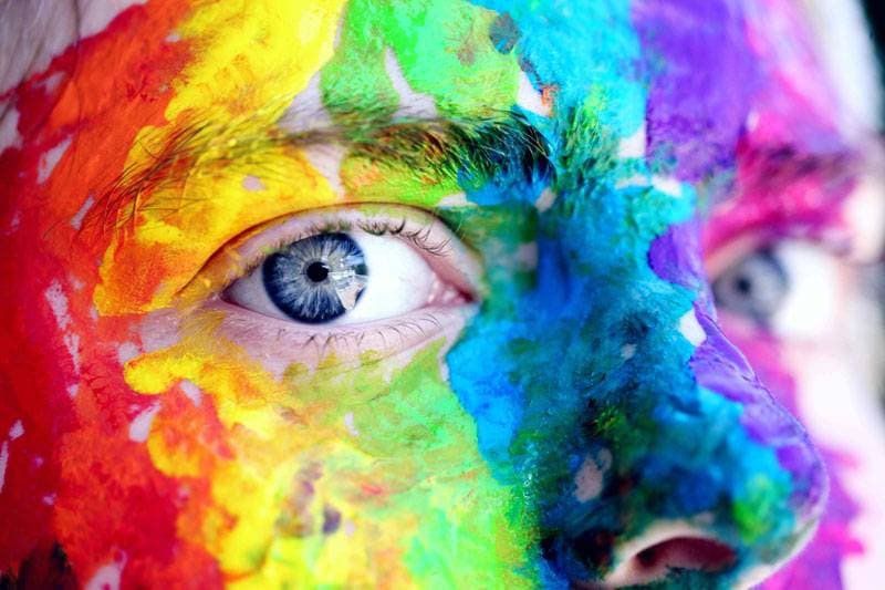 person with colorful paint on their face 