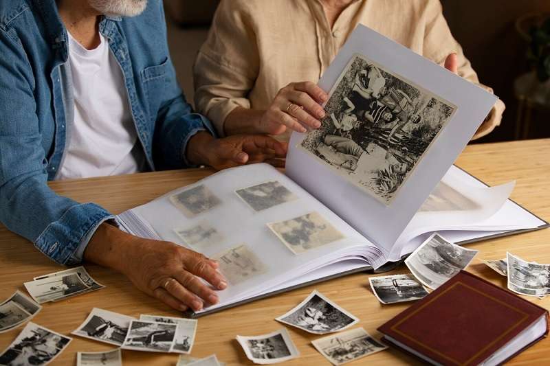 old couple looking at picture album