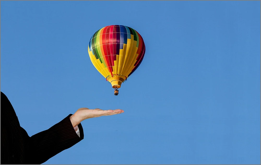 a hand launching an air balloon