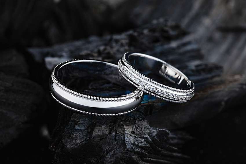 white gold ring photography with a black wood background
